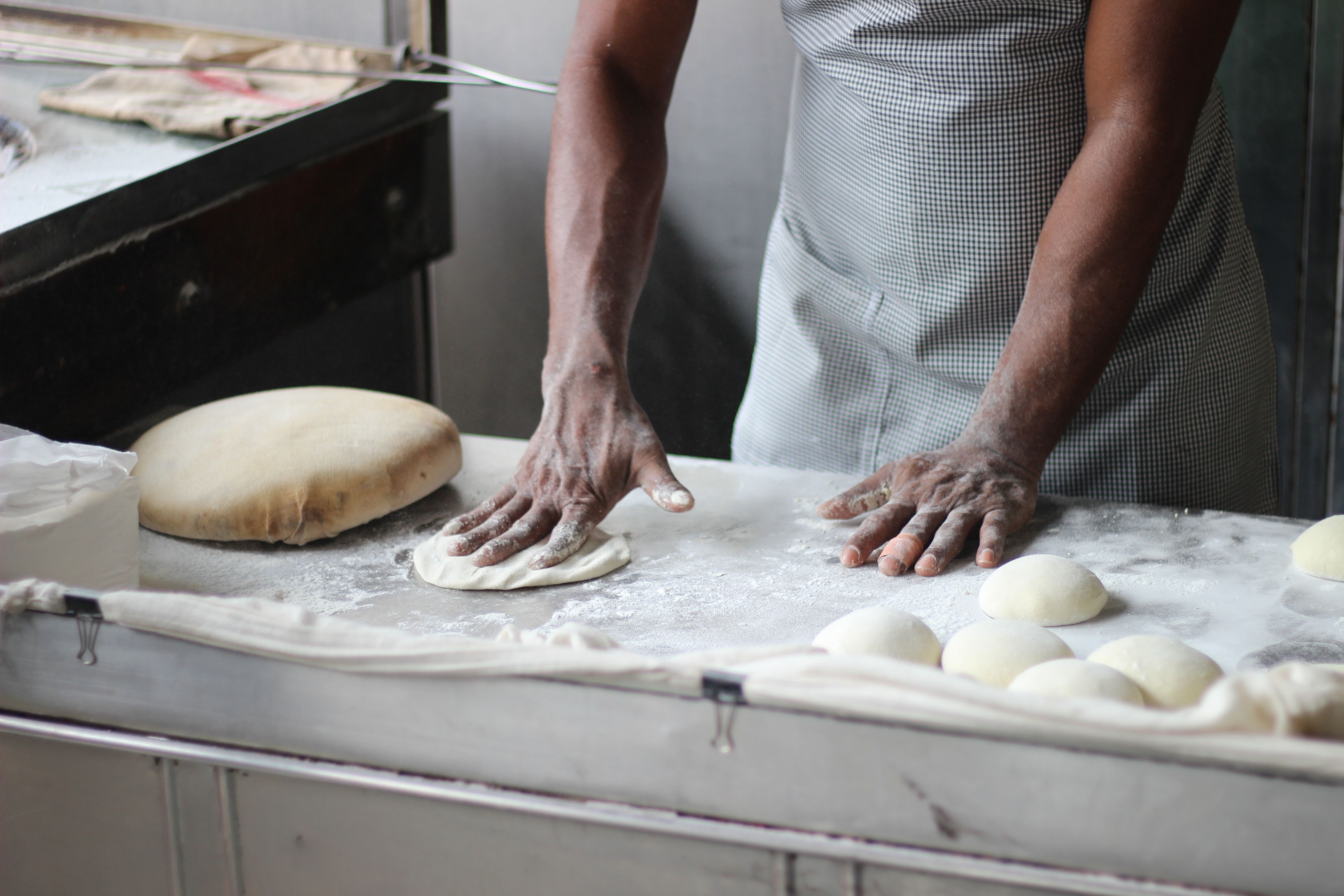 Hands kneading dough in a bakery