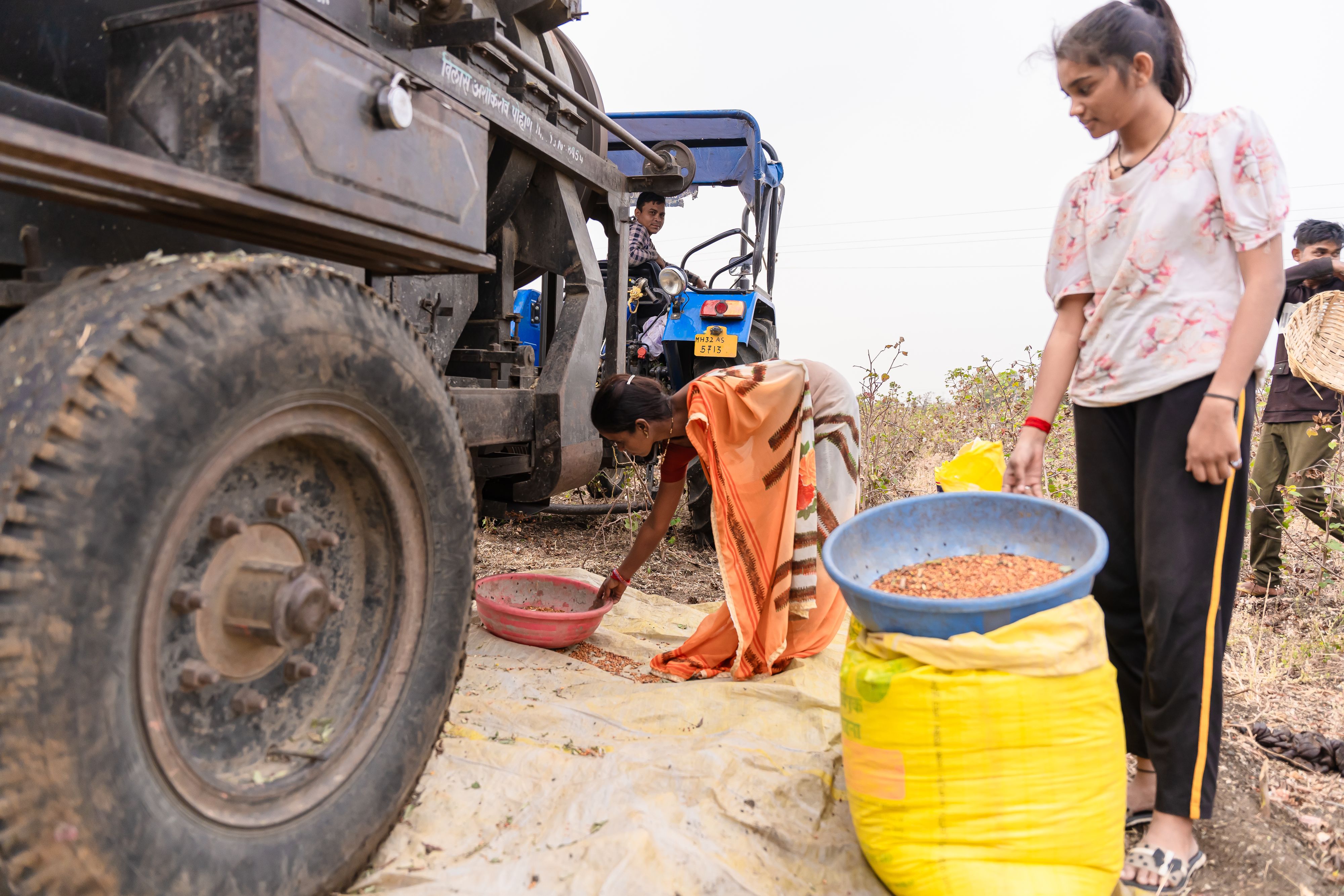 A woman farmer beside a tractor