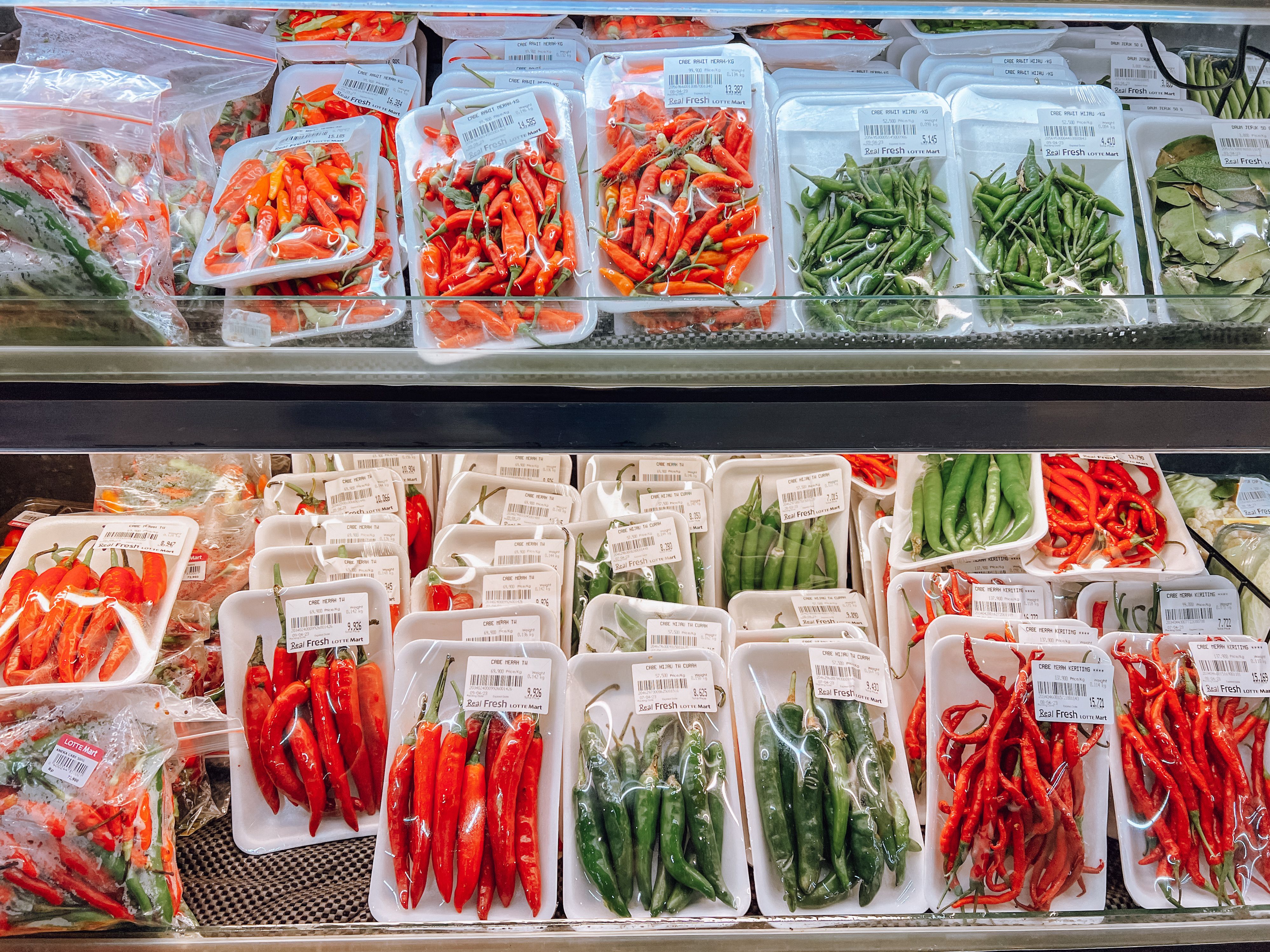 Chillies packed in trays on supermarket shelves