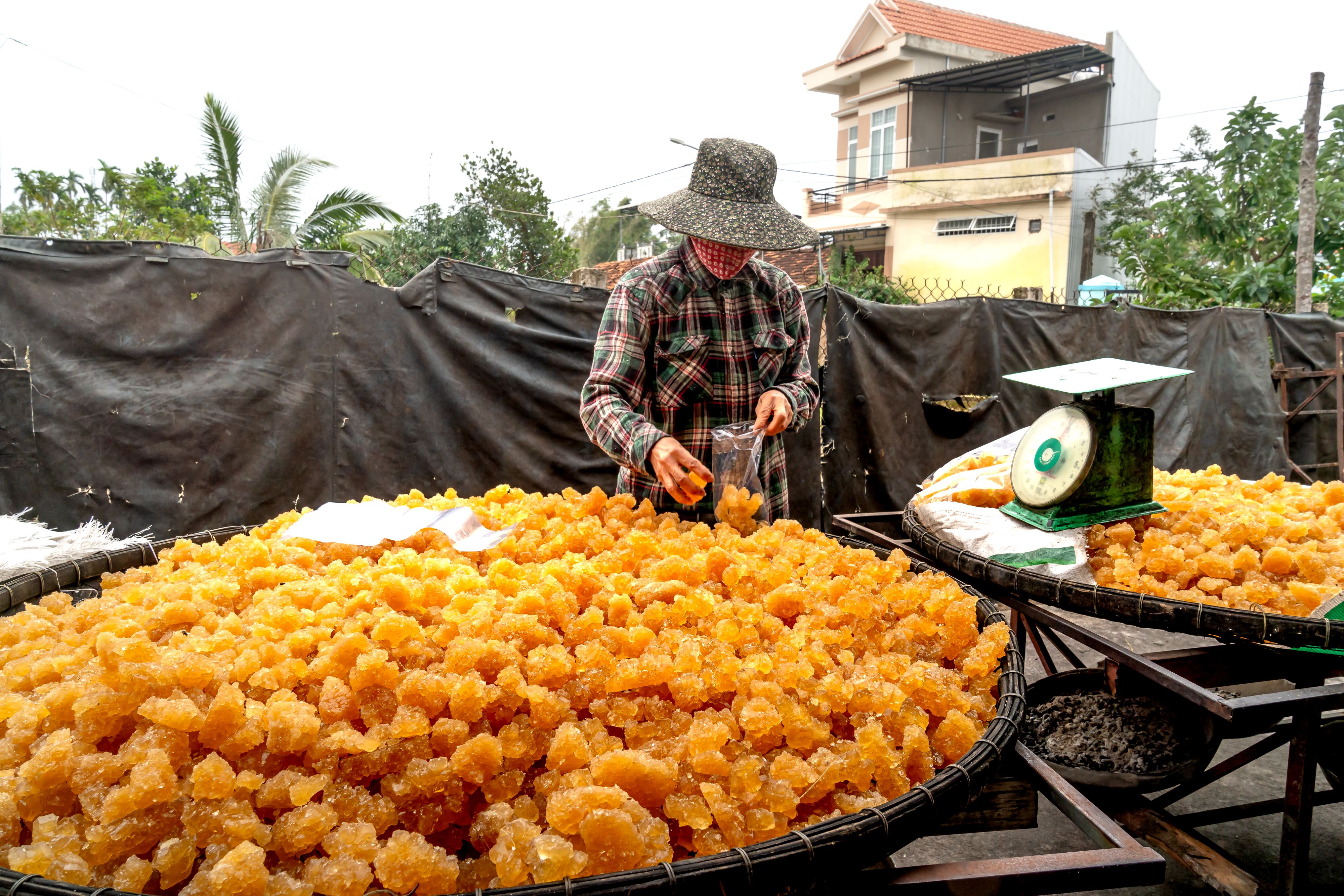 Fresh jaggery cooling in a large pan